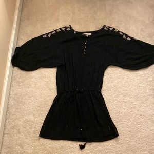 Mini black dress with white and blue designs on shoulders